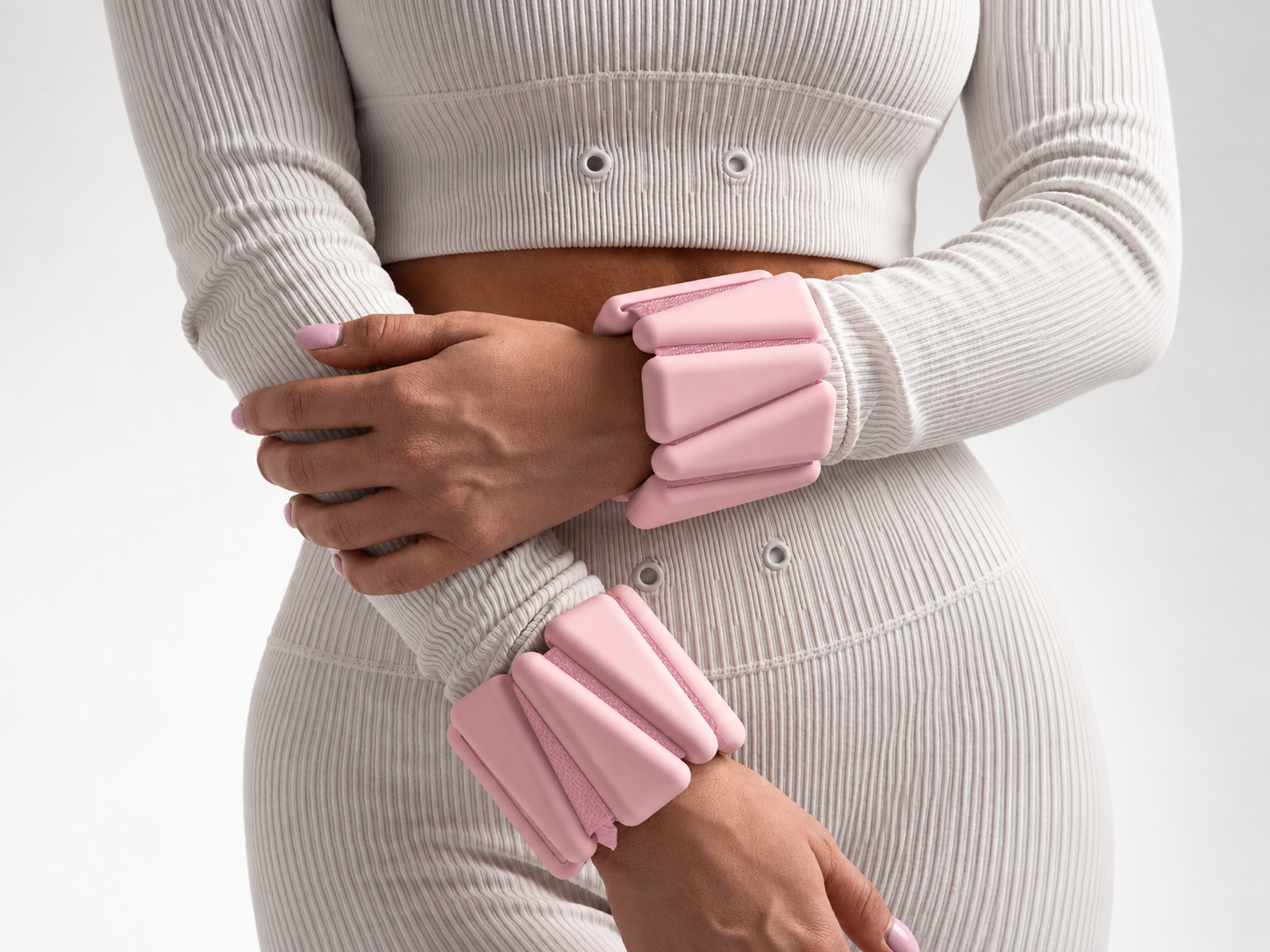 Pink wrist weights styled with a white Pilates set